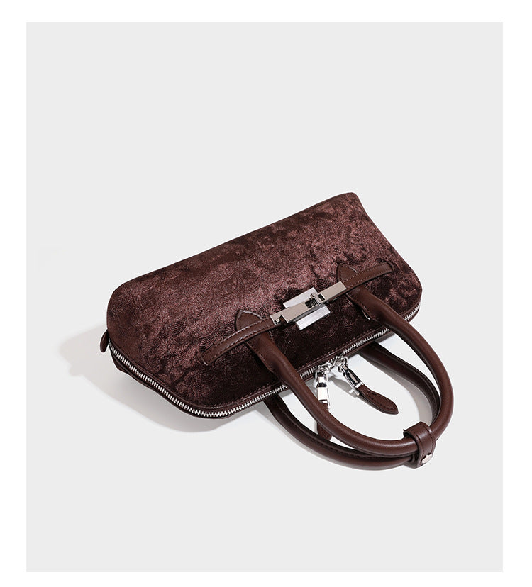 Small structured satchel bag in dark brown velvet-like textured finish with leather-look trim, silver-tone turn-lock bar