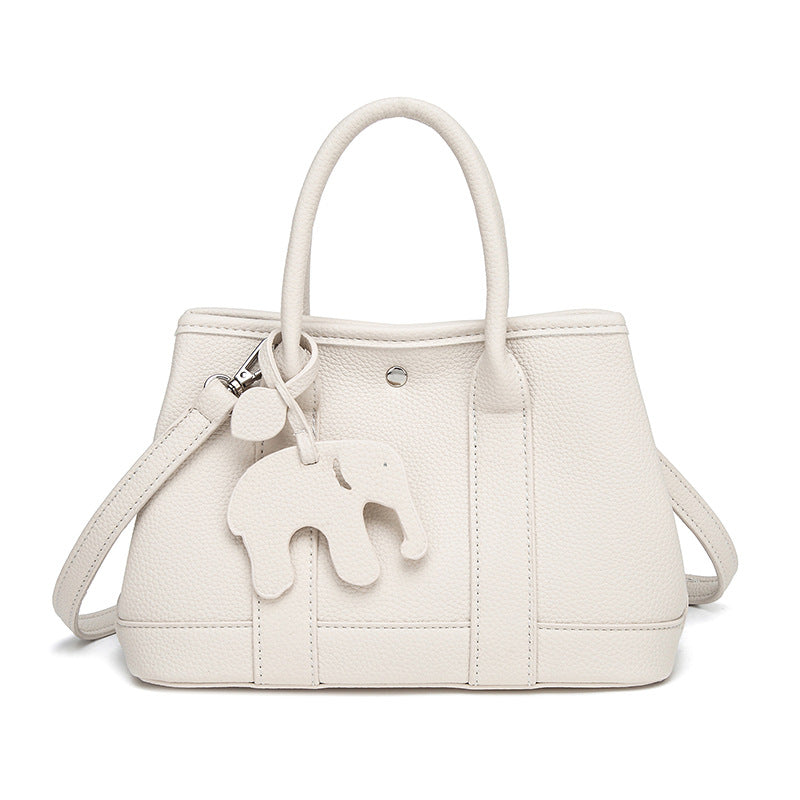 Structured pebbled leather-look top-handle tote bag with elephant charm and detachable shoulder strap, detail view 11