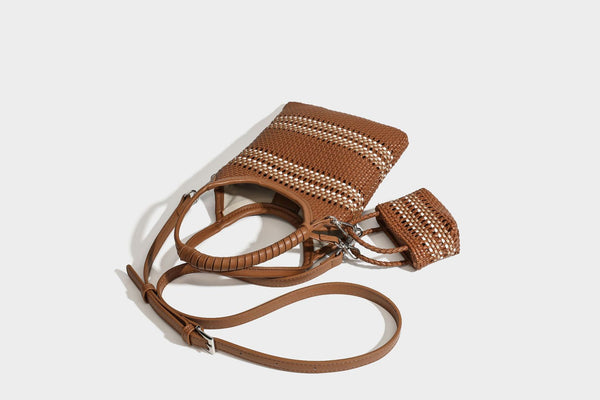 Color-block woven tote bag with rounded leather-look handles, detachable crossbody strap, and matching mini clip-on pouch in