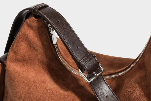 Slouchy cognac brown matte suede-look hobo shoulder bag with dark brown leather-look trim, top zip closure, front flap