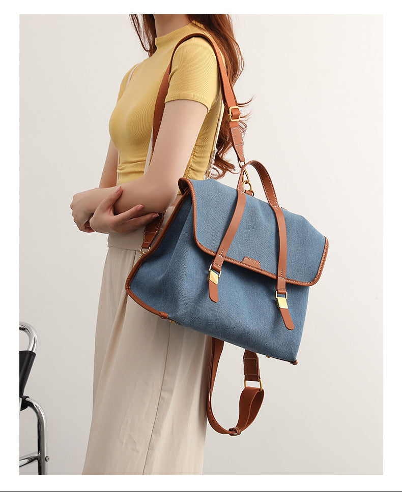 Strukturierter wandelbarer Rucksack in Denim-Optik mit Besatz in cognacfarbener Lederoptik, goldfarbenen Schnallenbeschlägen und oberem Tragegriff