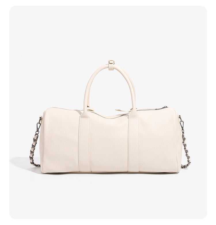 Large cream white pebbled leather-look barrel travel bag with twin top handles, chunky chain shoulder strap, front zip