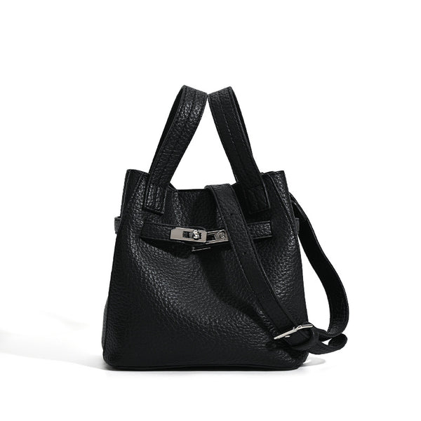 Small structured pebbled leather-look bucket bag with silver turn-lock bar hardware and dual top handles, detail view 5