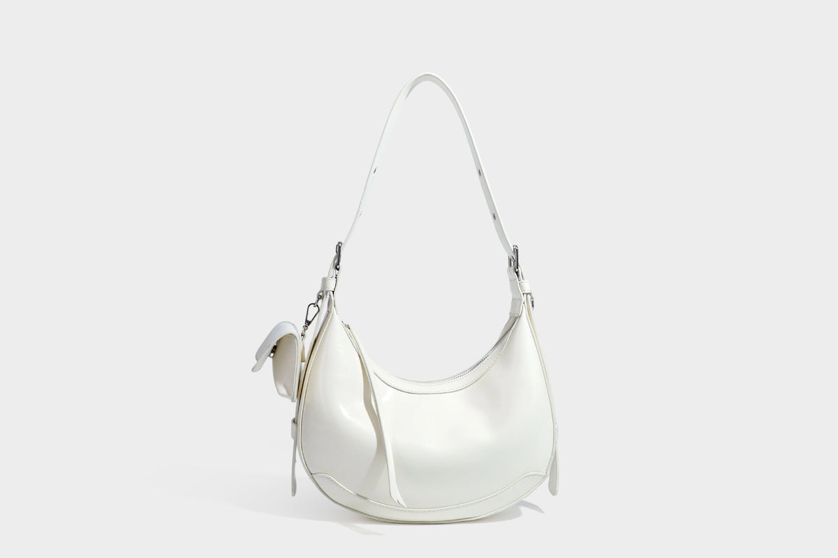 Glossy leather-look crescent hobo shoulder bag with dark contrast trim, silver-tone hardware, and attached mini flap pouch
