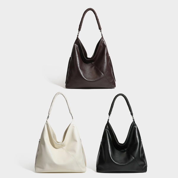 Large slouchy hobo shoulder bag with braided top handle, smooth glossy leather-look finish, and silver-tone ring hardware