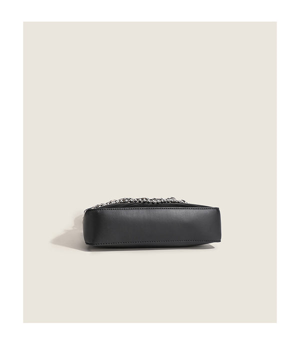 Small trapezoid shoulder bag with ripple leather-look finish, silver butterfly front clasp, and layered chain-and-ball strap