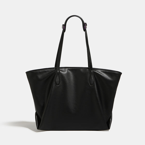 Large black leather-look trapezoid tote bag with double shoulder straps and purple accent hardware, detail view 6