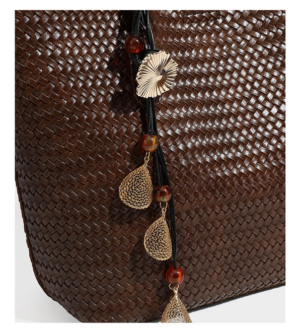 Large open-top woven leather-look tote bag in dark brown with scalloped edge, braided double shoulder straps, and decorative
