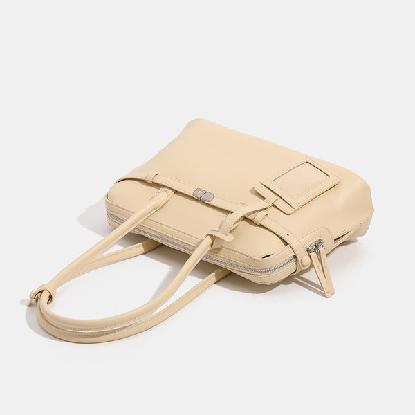 Structured leather-look zip-top tote satchel with twin handles, front turn-lock strap, hanging ID tag, and silver-tone
