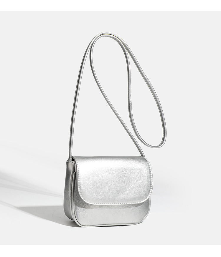 Compact rounded rectangular flap crossbody bag with glossy leather-look finish and long shoulder strap, detail view 15