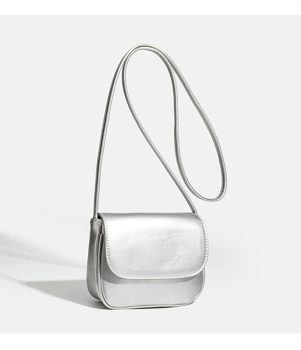 Compact rounded rectangular flap crossbody bag with glossy leather-look finish and long shoulder strap, detail view 15