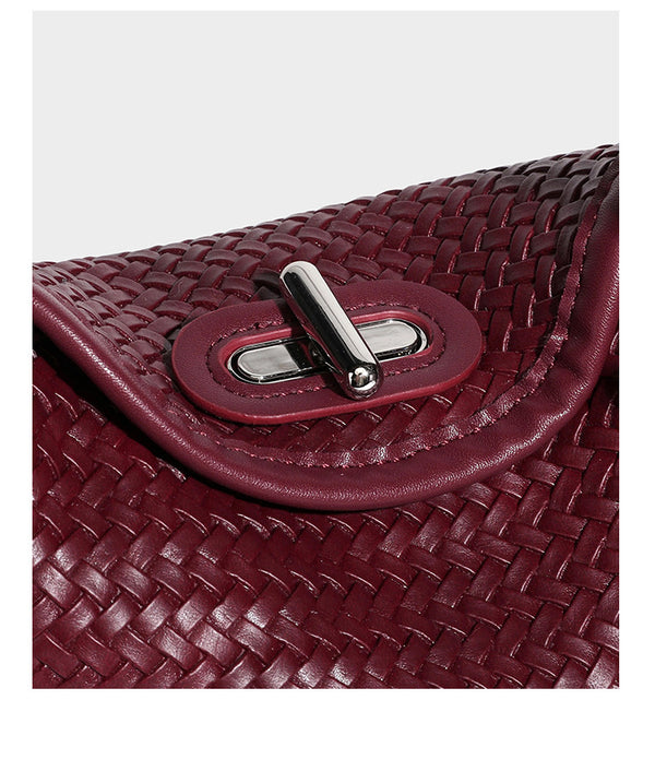 Small woven-look leather-look flap shoulder hobo bag in burgundy with silver-tone hardware and decorative tassel charm