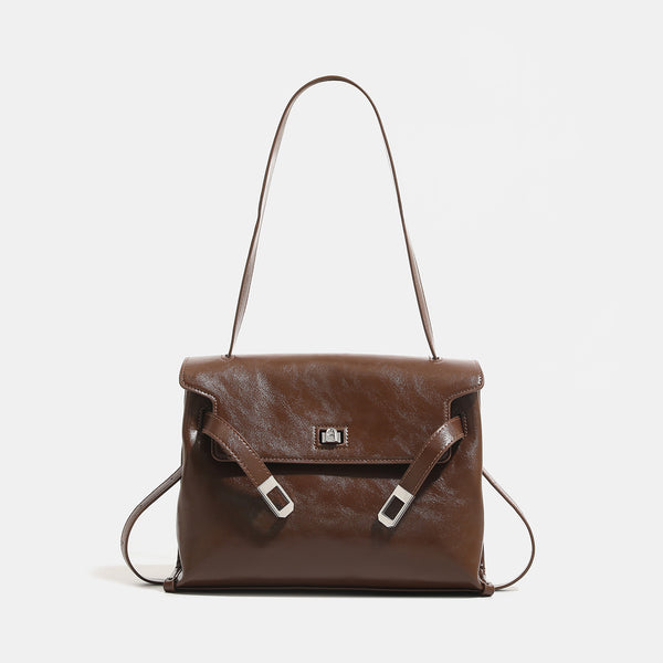 Structured rectangular flap shoulder bag in glossy leather-look finish with silver turn-lock clasp and adjustable strap