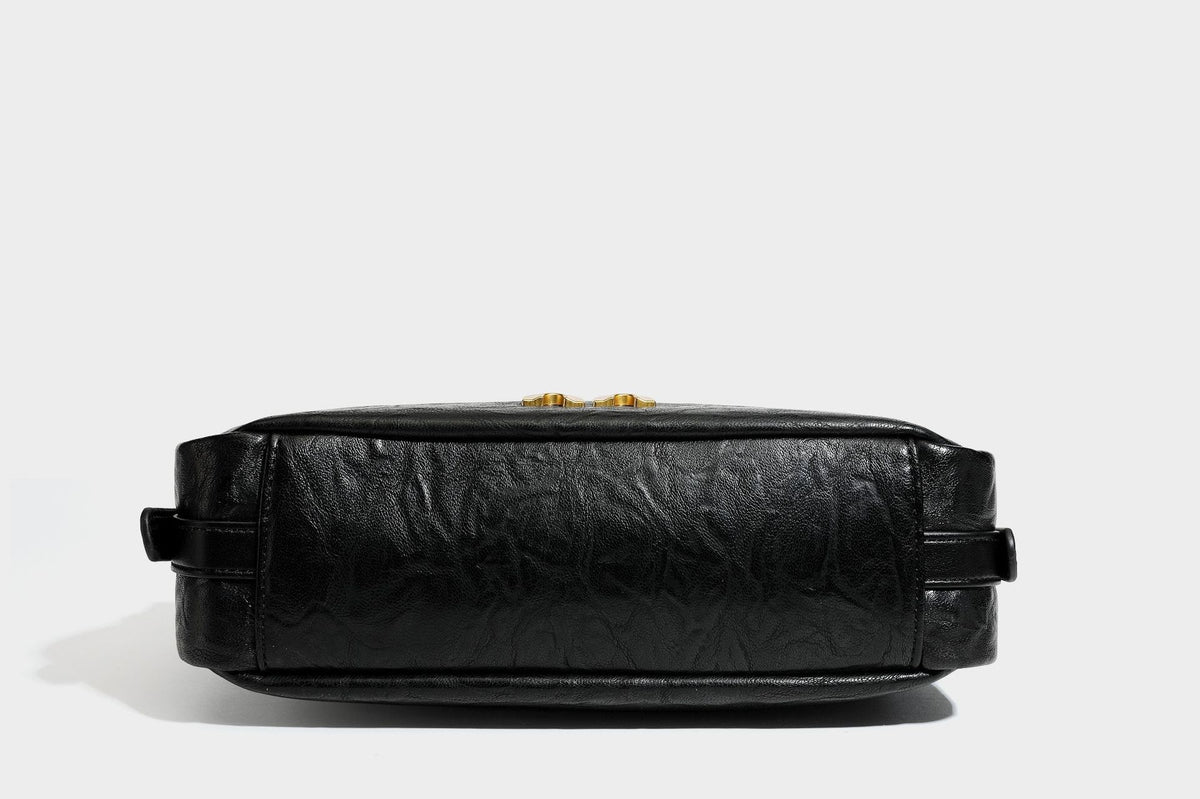 Compact black crinkled leather-look baguette shoulder bag with gold-tone arch hardware and adjustable strap, detail view 34