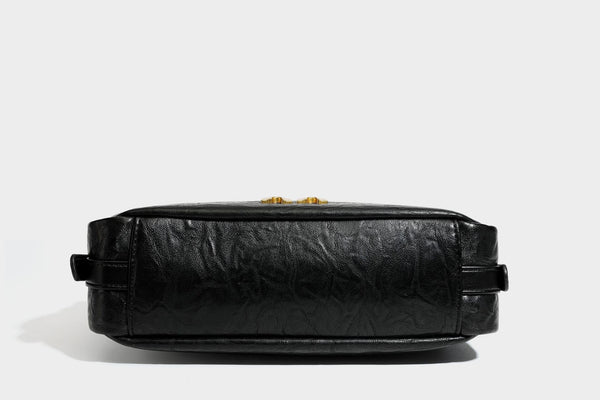 Compact black crinkled leather-look baguette shoulder bag with gold-tone arch hardware and adjustable strap, detail view 34