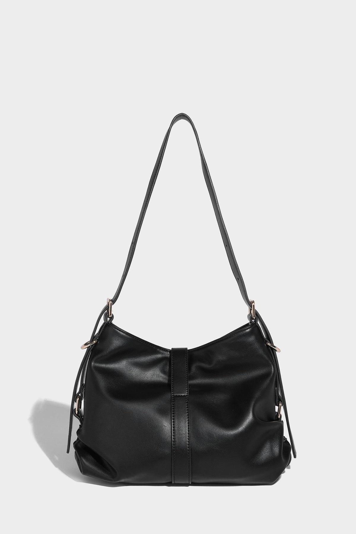 Soft slouchy hobo shoulder bag with smooth leather-look finish, gold-tone buckle and tab hardware, and long adjustable strap