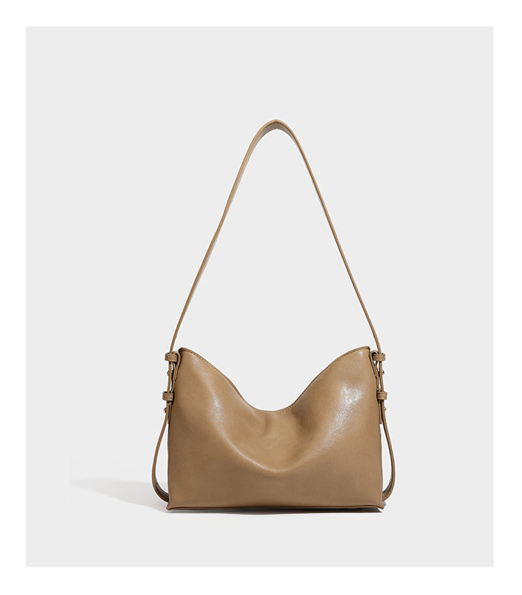 Slouchy suede-finish brown shoulder bag with long single strap and small gold-tone logo emblem on front, detail view 19