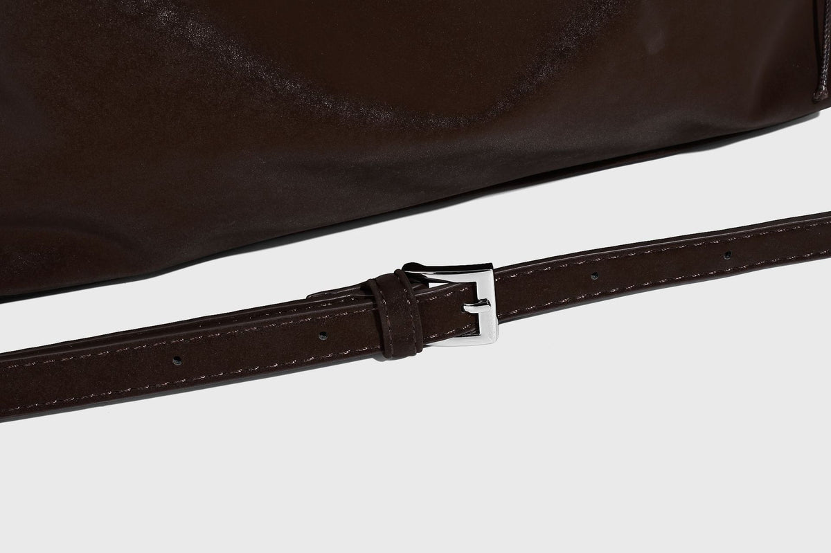 Slouchy matte-finish hobo shoulder bag with tassel cords, silver-tone hardware, and faux-fur pom charm, detail view 21