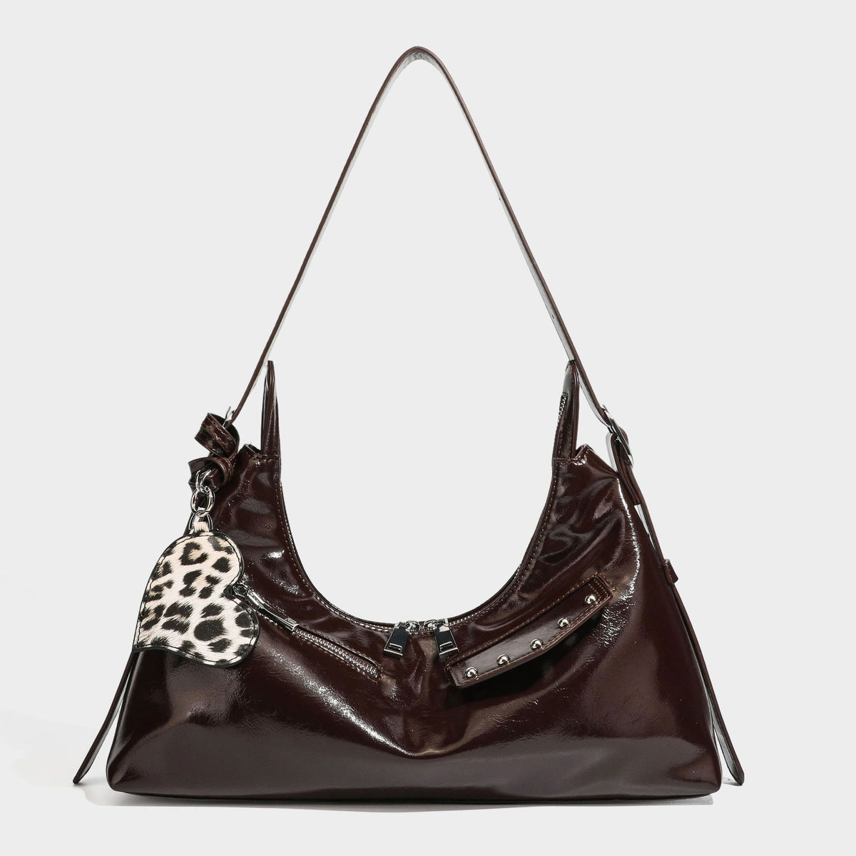 Glossy dark brown hobo shoulder bag with slim strap, front zip pocket, stud detail, and detachable leopard-print heart charm