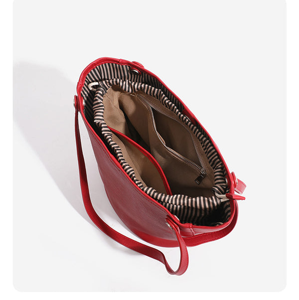 Large leather-look bucket tote bag with dual top handles and adjustable crossbody strap, detail view 20