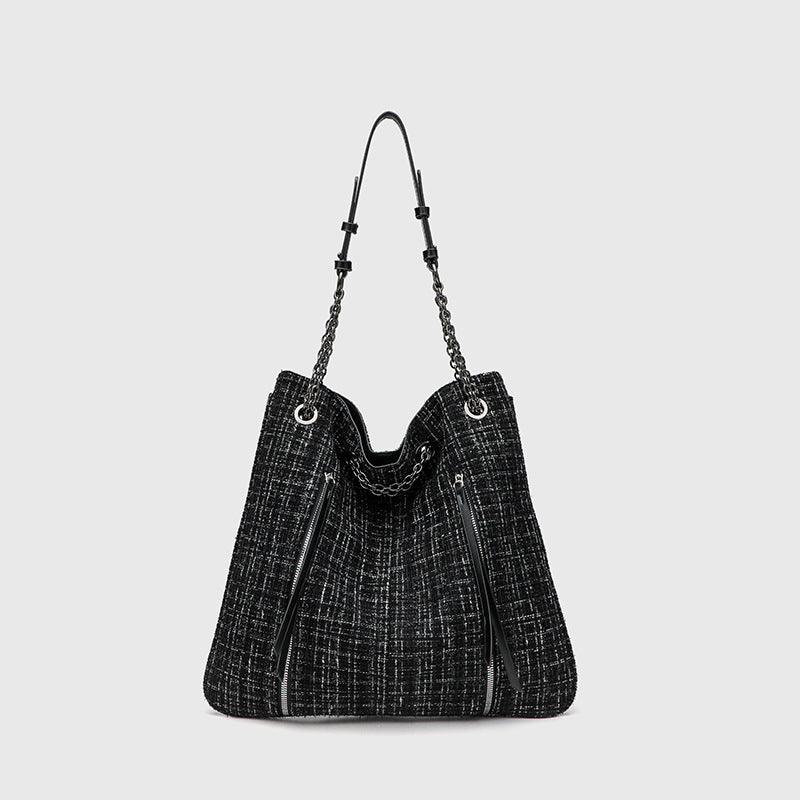 Large black tweed-texture shoulder tote bag with silver-tone chain and leather-look straps, metal eyelets, and exterior zip