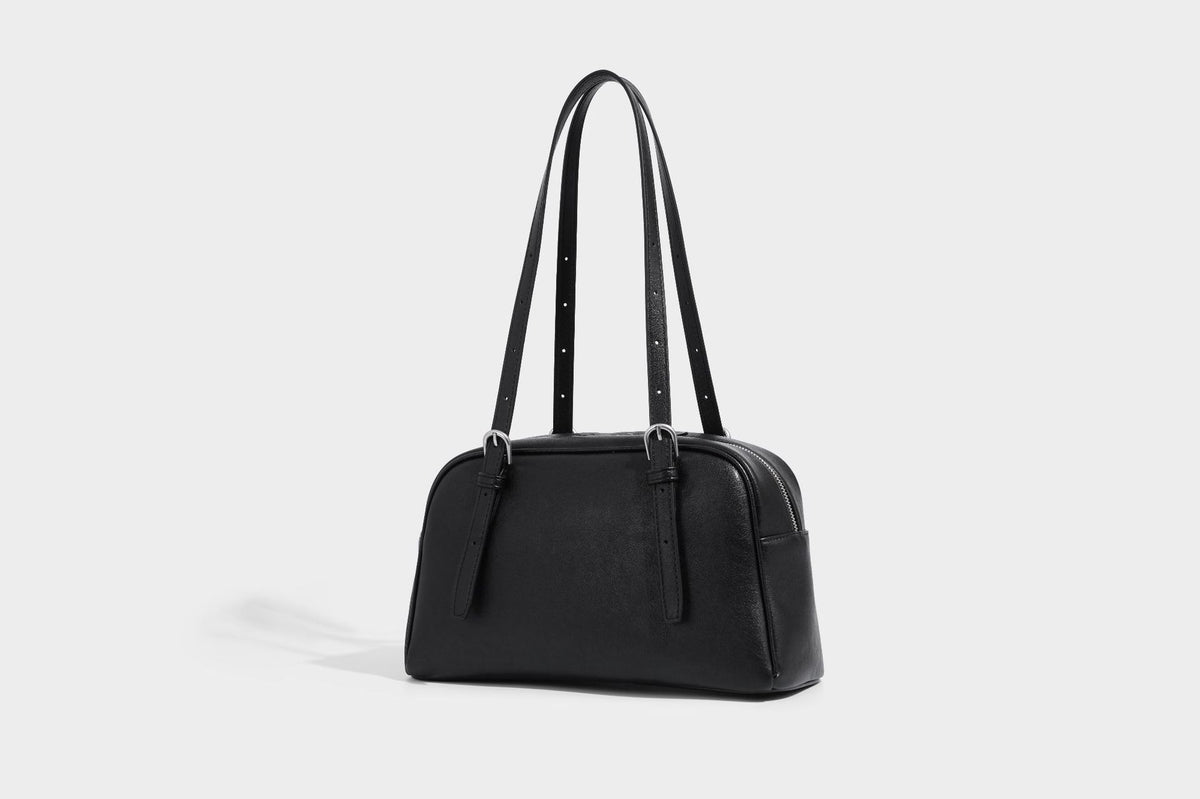 Structured dome-shaped shoulder bag with leather-look finish, top zipper closure, dual adjustable slim straps, and, detail