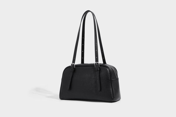 Structured dome-shaped shoulder bag with leather-look finish, top zipper closure, dual adjustable slim straps, and, detail