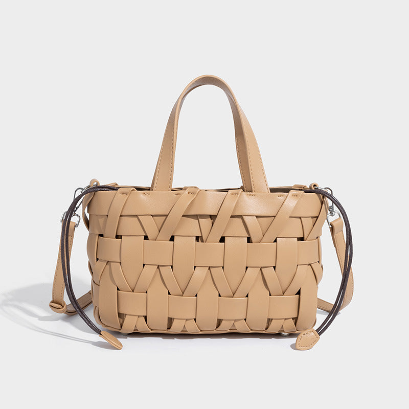 Structured woven basket tote handbag with contrasting dark trim, double top handles, detachable shoulder strap, and