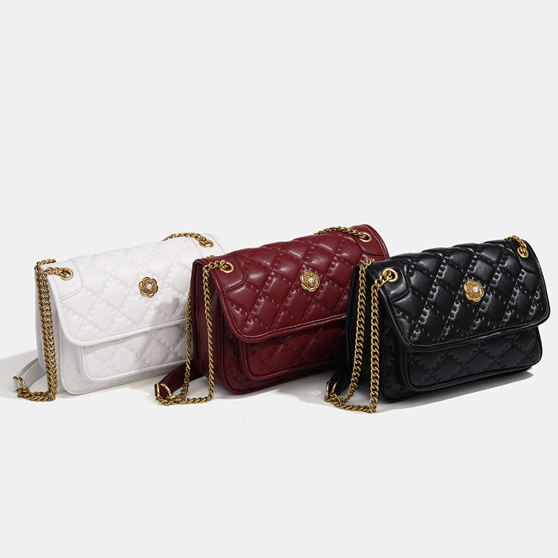 Compact diamond-quilted flap shoulder bag with gold-tone chain strap and floral turn-lock clasp, detail view 2