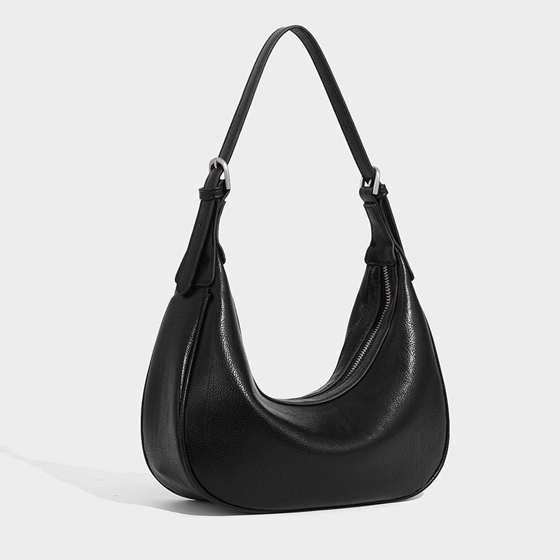Crescent half-moon shoulder bag in pebbled leather-look finish with adjustable strap and silver-tone hardware, front view