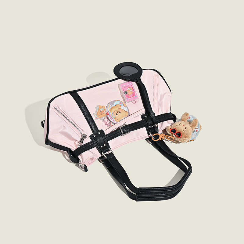 Pale pink nylon tote bag with black leather-look trim, double top handles, side zip pocket, and detachable crossbody strap