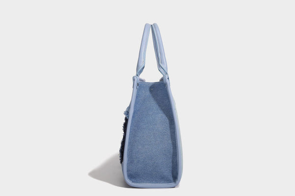Structured patchwork denim tote bag with frayed panel seams, dual top handles, and silver-tone hardware, detail view 13