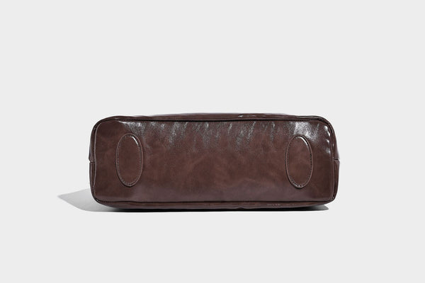 Glossy slouchy hobo shoulder bag with adjustable strap and embossed floral emblem, detail view 22