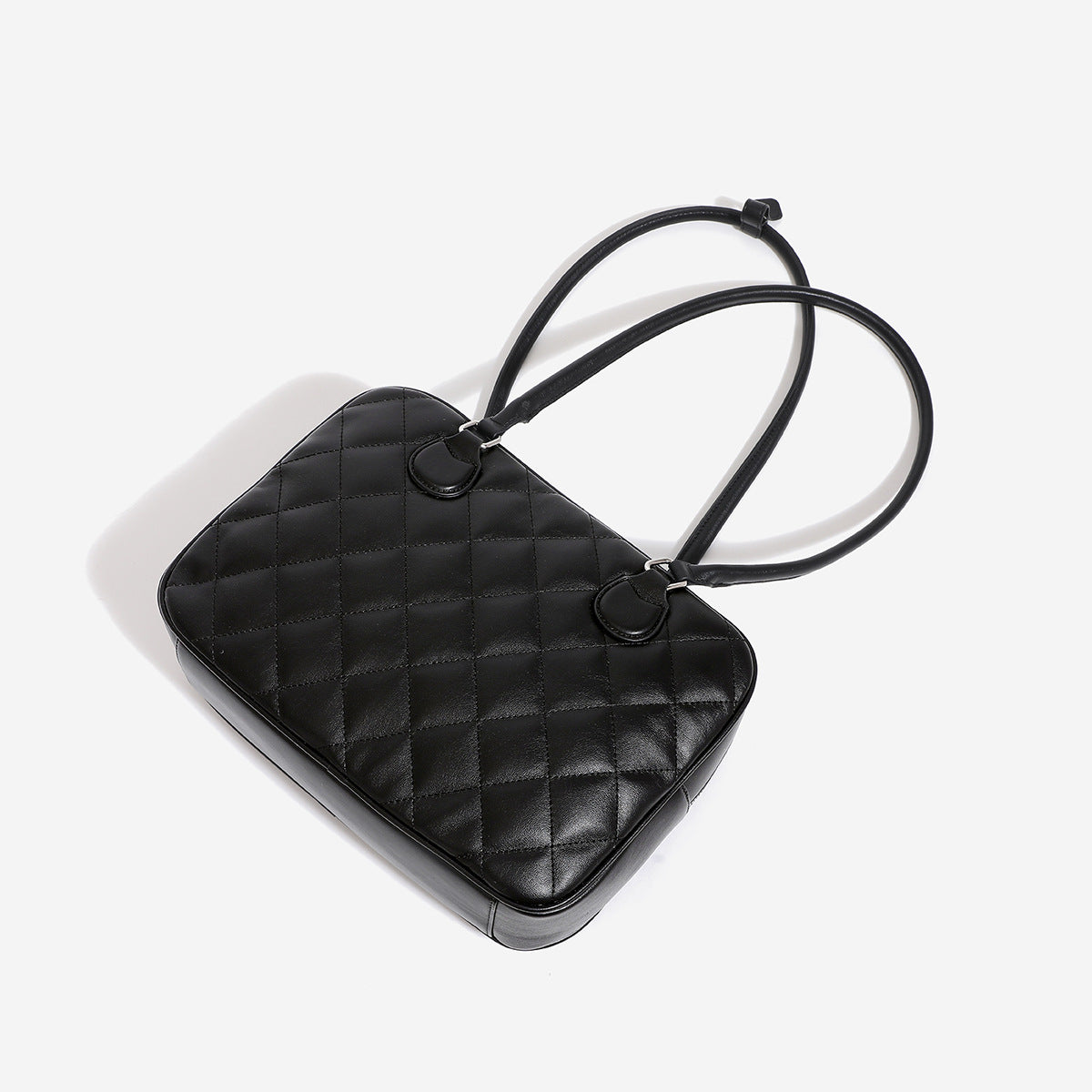 Structured diamond-quilted bowling shoulder bag with silver-tone hardware and top zip closure, detail view 4