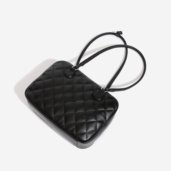 Structured diamond-quilted bowling shoulder bag with silver-tone hardware and top zip closure, detail view 4
