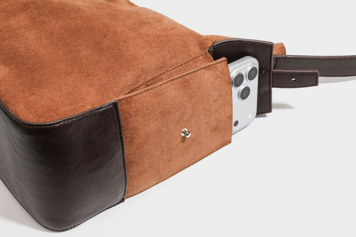 Slouchy cognac brown matte suede-look hobo shoulder bag with dark brown leather-look trim, top zip closure, front flap