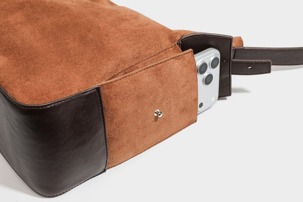 Slouchy cognac brown matte suede-look hobo shoulder bag with dark brown leather-look trim, top zip closure, front flap