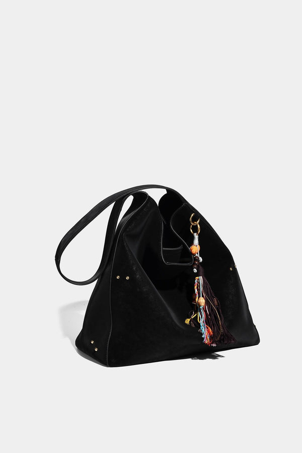 Oversized trapezoid tote bag with matte leather-look finish, gold-tone rivets, and long shoulder strap, detail view 17