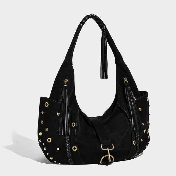 Slouchy crescent hobo bag in matte brown suede-like finish with gold-tone studs, grommets, braided top handle, tassel side