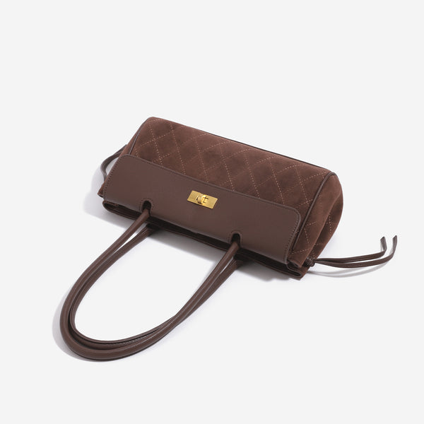 Structured diamond-quilted baguette shoulder bag with gold-tone turn-lock closure and side drawstring ties, detail view 4