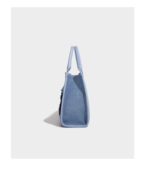 Structured patchwork denim tote bag with frayed panel seams, dual top handles, and silver-tone hardware, detail view 9
