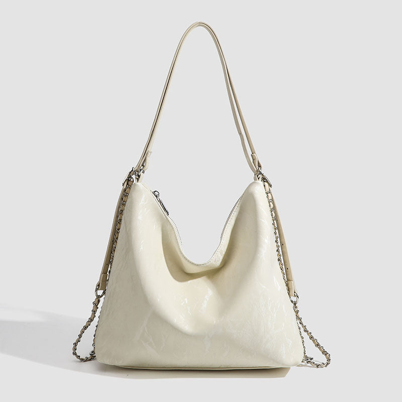 Lässige Hobo-Schultertasche mit glänzender, geknitterter Oberfläche, silberfarbenen Kettenriemen und Reißverschluss, Vorderansicht
