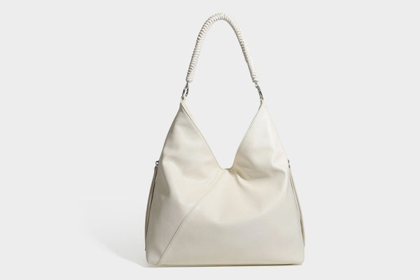 Large slouchy hobo shoulder bag with braided top handle, smooth glossy leather-look finish, and silver-tone ring hardware