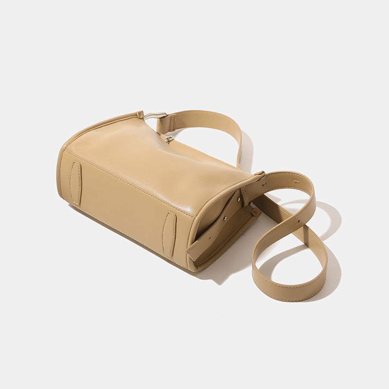 Structured smooth leather-look shoulder bag with top zip closure, tassel pull, and adjustable crossbody strap in khaki