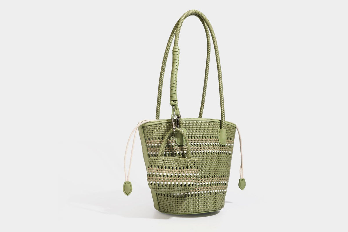 Light blue open-weave woven bucket tote bag with long braided shoulder straps, drawstring side ties, and attached mini pouch