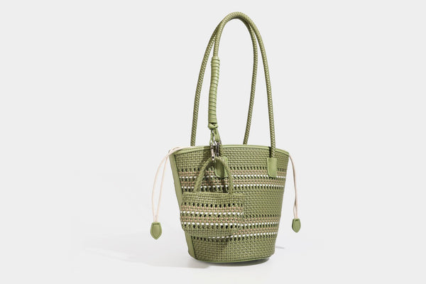 Light blue open-weave woven bucket tote bag with long braided shoulder straps, drawstring side ties, and attached mini pouch