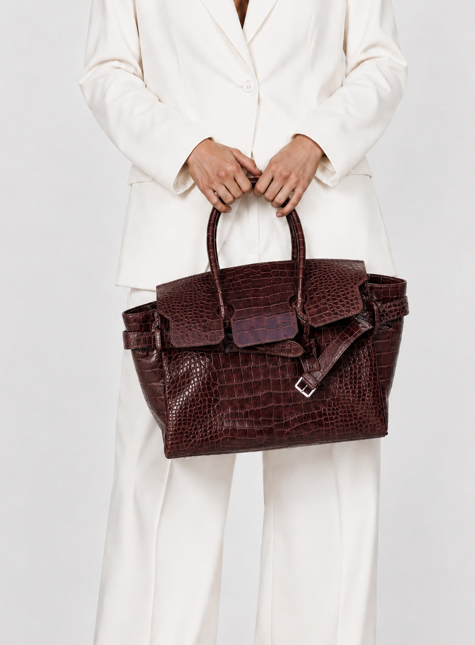 Large structured tote satchel with glossy crocodile-embossed leather-look finish, dual top handles, and metal buckle flap