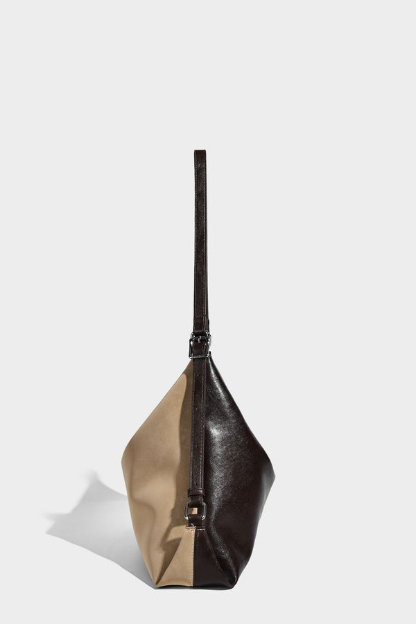 Slouchy hobo tote bag with matte leather-look finish, triangular silhouette, front zip pocket, and adjustable shoulder strap