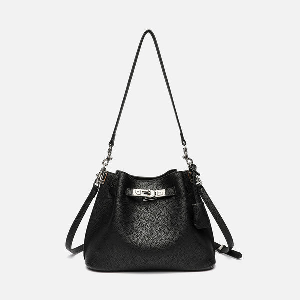Soft-structured pebbled leather-look bucket bag with silver turn-lock front clasp and adjustable crossbody strap, detail view