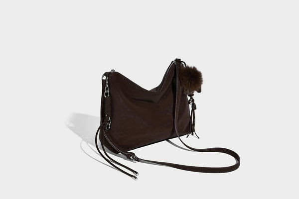 Slouchy matte-finish hobo shoulder bag with tassel cords, silver-tone hardware, and faux-fur pom charm, detail view 16